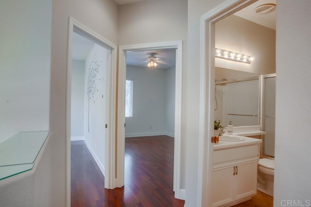 6094 Citracado Circle Carlsbad, CA 92009 - Photo 20 of 47 a bathroom with a sink a mirror and a shower