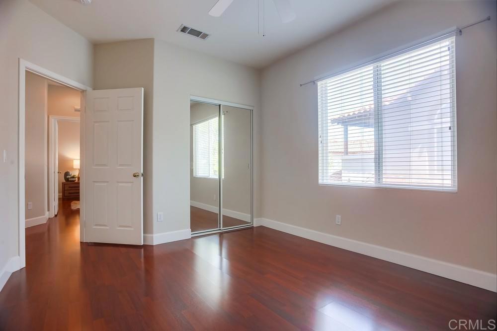 6094 Citracado Circle Carlsbad, CA 92009 - Photo 23 of 47 a view of an empty room with wooden floor and a window