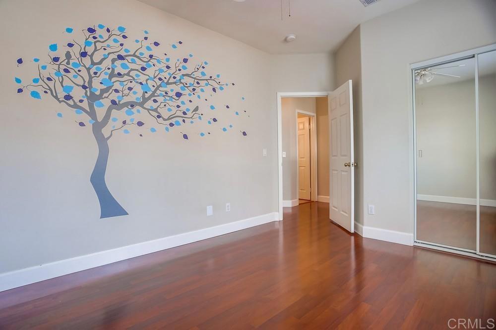 6094 Citracado Circle Carlsbad, CA 92009 - Photo 24 of 47 an empty room with wooden floor and cabinet