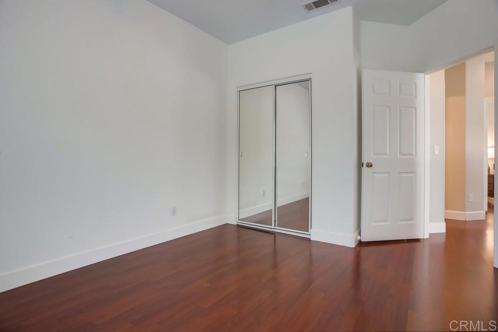 6094 Citracado Circle Carlsbad, CA 92009 - Photo 26 of 47 a view of an empty room with wooden floor