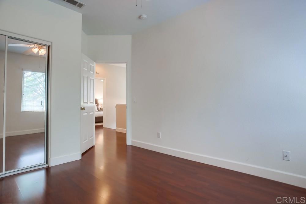6094 Citracado Circle Carlsbad, CA 92009 - Photo 27 of 47 a view of a hallway with wooden floor