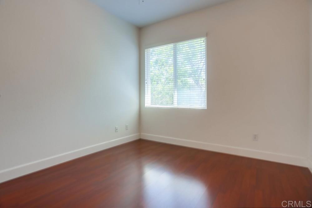 6094 Citracado Circle Carlsbad, CA 92009 - Photo 28 of 47 an empty room with wooden floor and windows