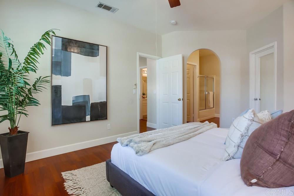 6094 Citracado Circle Carlsbad, CA 92009 - Photo 32 of 47 a bedroom with a large bed and a flat tv screen