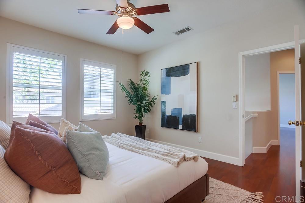 6094 Citracado Circle Carlsbad, CA 92009 - Photo 33 of 47 a bedroom with a bed and a chandelier