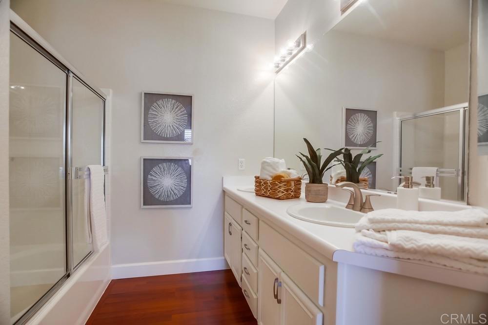 6094 Citracado Circle Carlsbad, CA 92009 - Photo 34 of 47 a bathroom with a double vanity sink and mirror