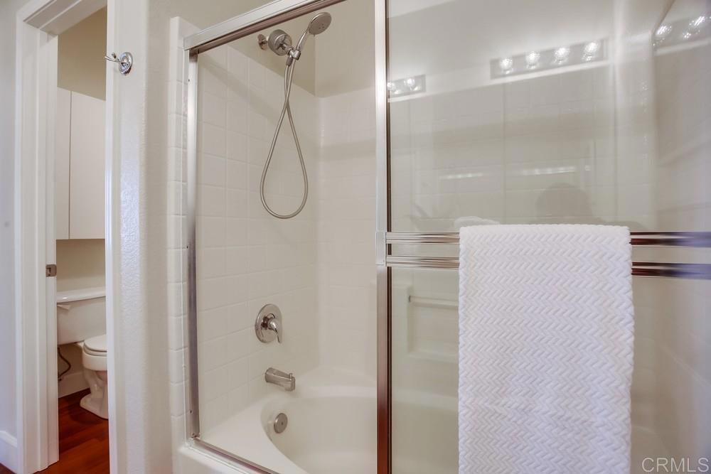 6094 Citracado Circle Carlsbad, CA 92009 - Photo 35 of 47 a bathroom with a shower and a glass door