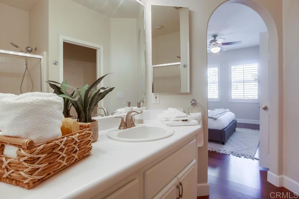 6094 Citracado Circle Carlsbad, CA 92009 - Photo 36 of 47 a en suite bathroom with a double vanity sink and a mirror