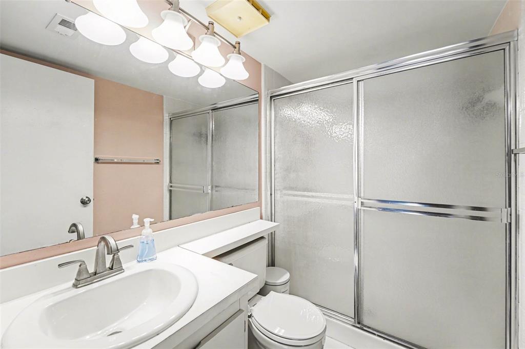 1261 Pine Ridge Circle West, Unit D1 Tarpon Springs, FL 34688 - Photo 11 of 14 a bathroom with a sink toilet and shower