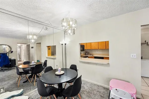 a view of a dining room with furniture and a chandelier
