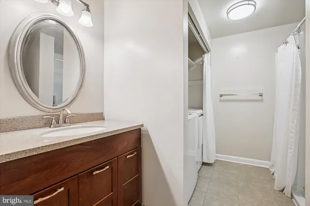 a bathroom with a granite countertop sink a mirror and a vanity