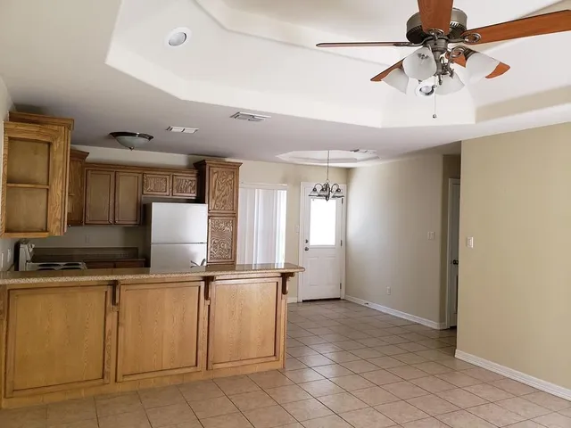 a kitchen with cabinets and stainless steel appliances