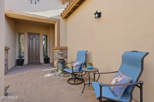a living room with furniture kitchen view and a chandelier