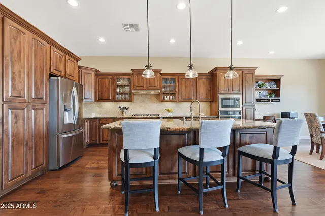 a kitchen with stainless steel appliances granite countertop a stove and a sink