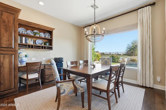 a view of a workspace with furniture and wooden floor