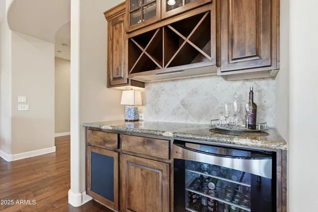 a spacious bedroom with a bed and a chandelier