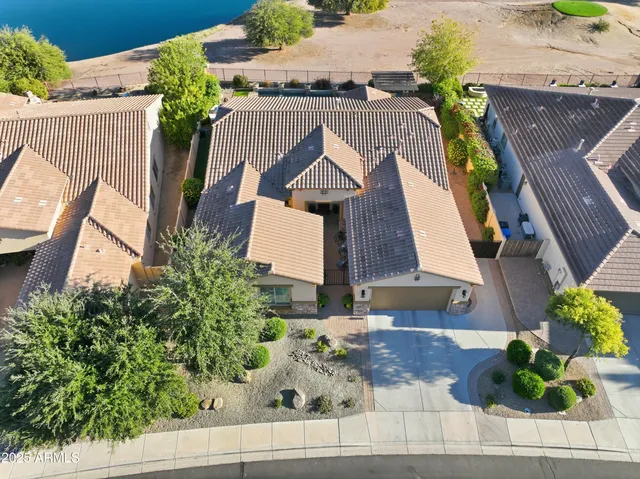an aerial view of residential houses with outdoor space and ocean