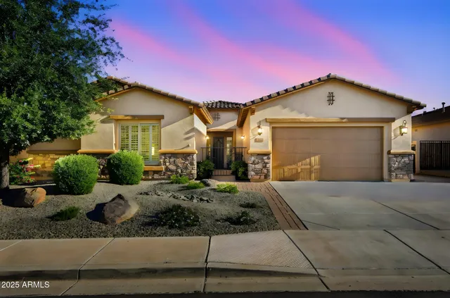 a view of a house with backyard swimming pool and sitting area