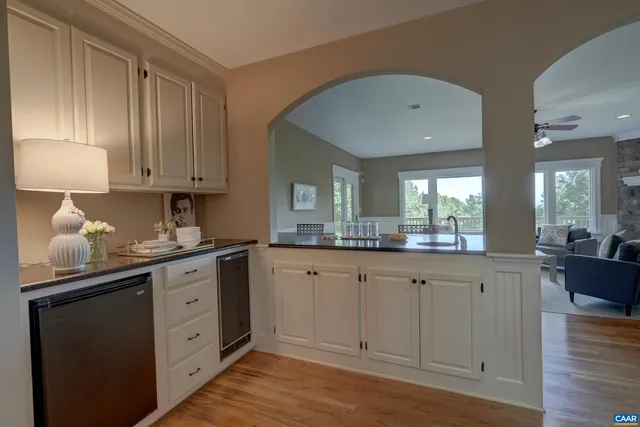 a dining room with furniture and a floor to ceiling window