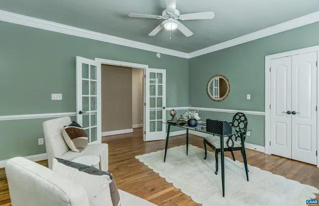 a view of a livingroom with a ceiling fan and window