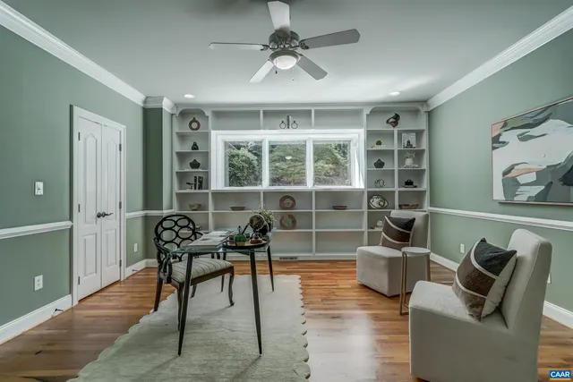 a view of a livingroom with a ceiling fan and window