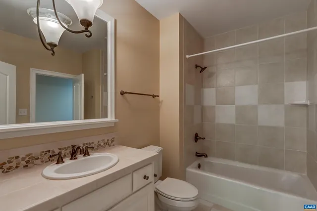 a living room with furniture a flat screen tv and a window