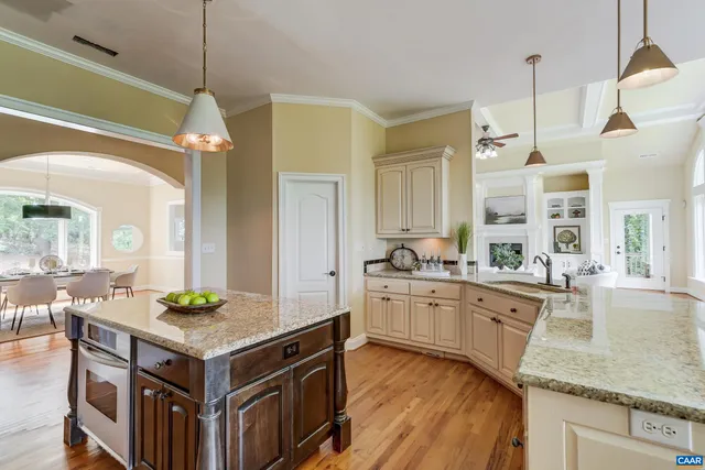 a kitchen with granite countertop a sink a center island and cabinets