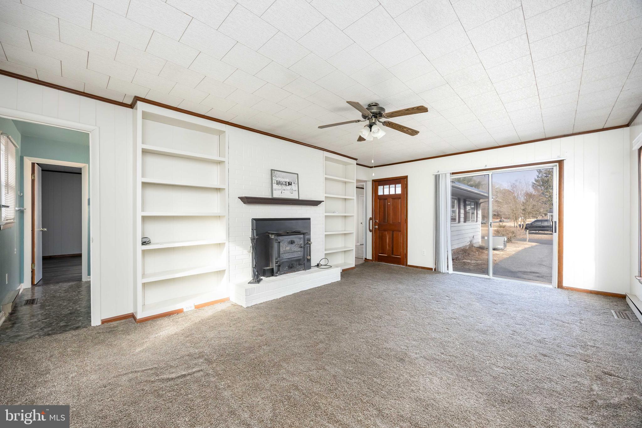 310 Zion Road Salisbury, MD 21804 - Photo 13 of 40 a view of an empty room with a fireplace and a window
