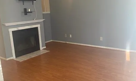 a view of an empty room with a fireplace