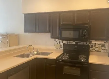 a kitchen with a sink and cabinets