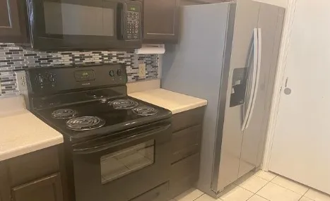 a stove top oven sitting inside of a kitchen