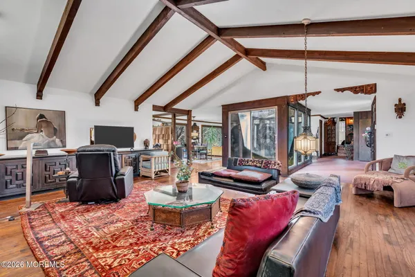 a living room with furniture and a floor to ceiling window