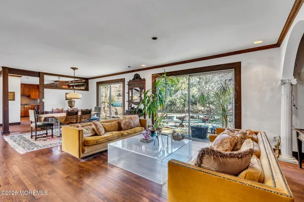 a living room with furniture and wooden floor