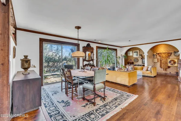 a dining room with wooden floor a chandelier
