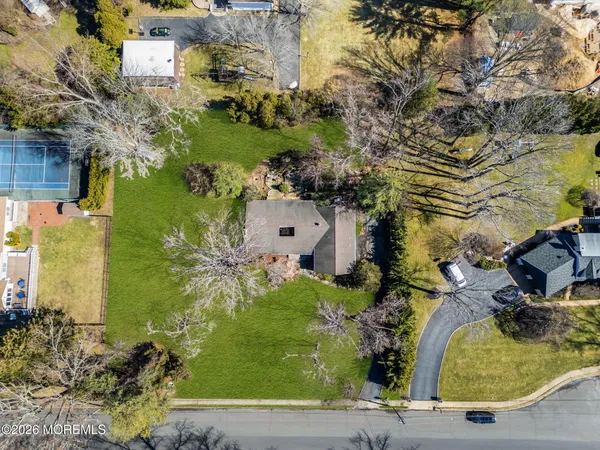 an aerial view of a house with a yard swimming pool and outdoor seating
