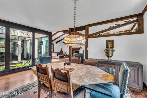 a view of a dining room with furniture window and wooden floor