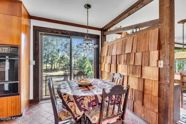 a view of a kitchen with a large window and dining table