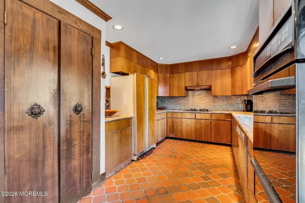 a kitchen with stainless steel appliances granite countertop a refrigerator and sink