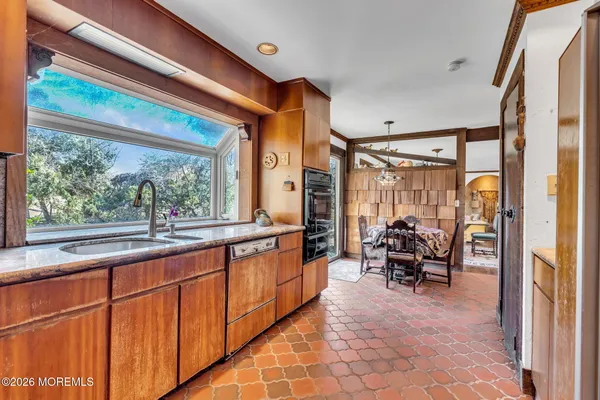 a kitchen with granite countertop a refrigerator and a sink