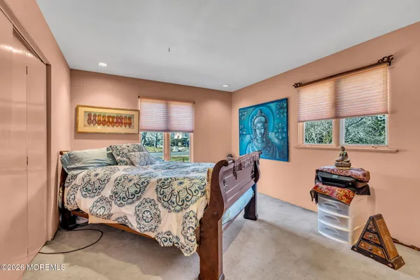 a bed room with a bed and a large window