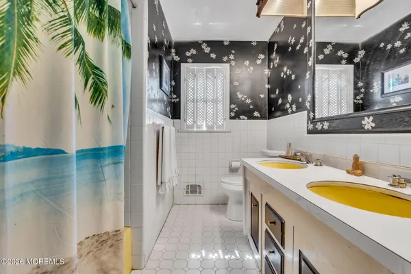 a bathroom with a sink a mirror and a shower