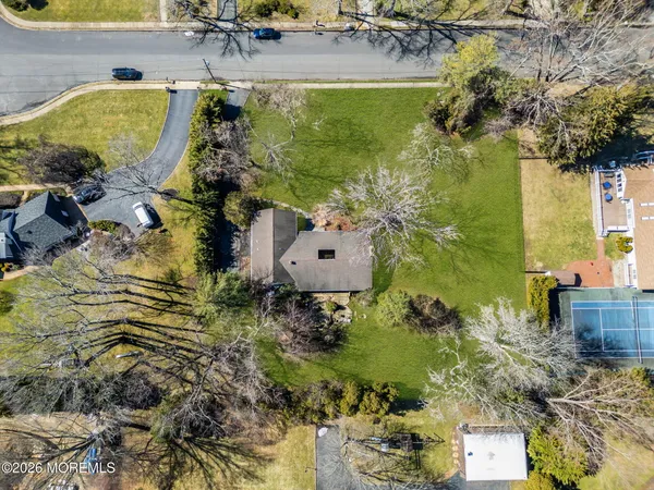 an aerial view of a house with a yard swimming pool and outdoor seating