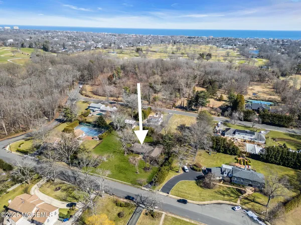 an aerial view of residential houses with outdoor space