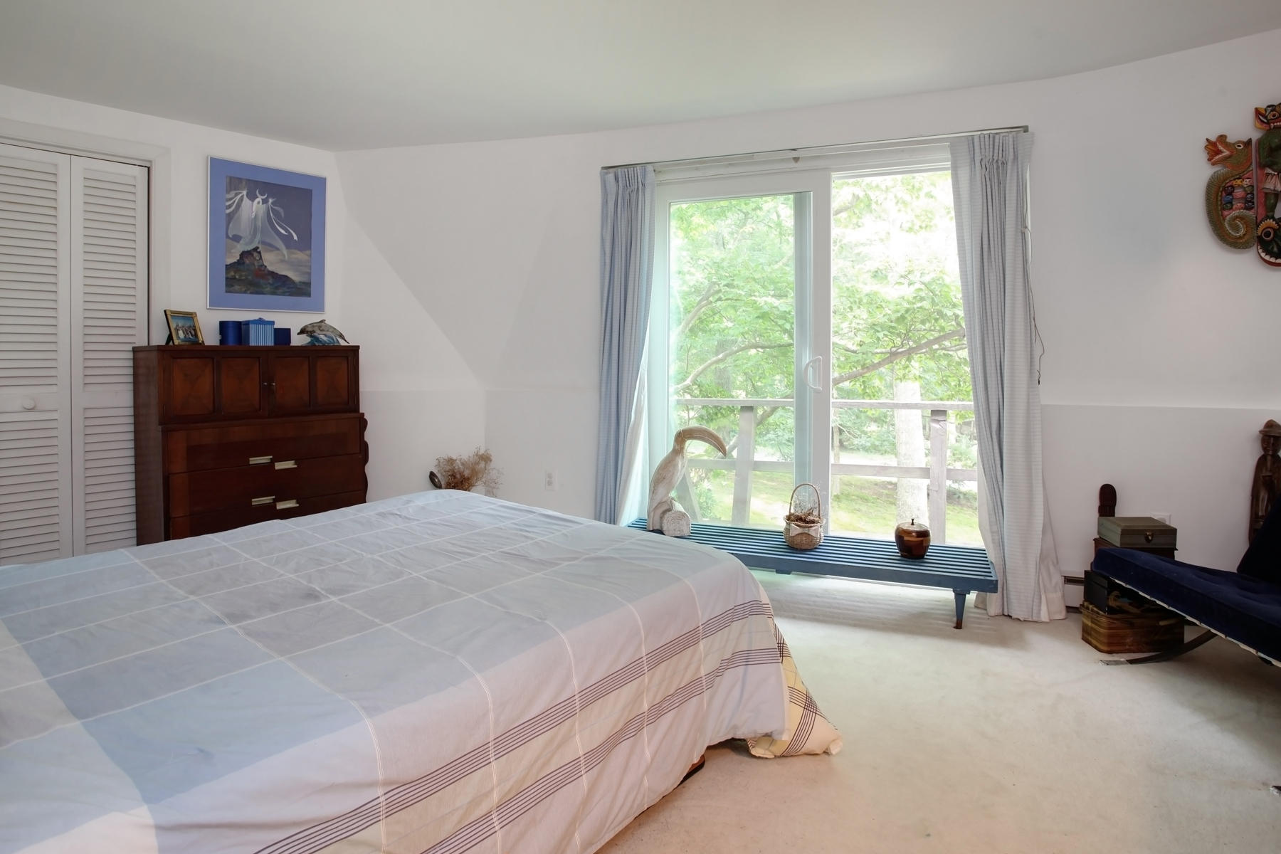 167 Ralyn Road Cotuit, MA 02635 - Photo 12 of 32 a spacious bedroom with a bed and a window