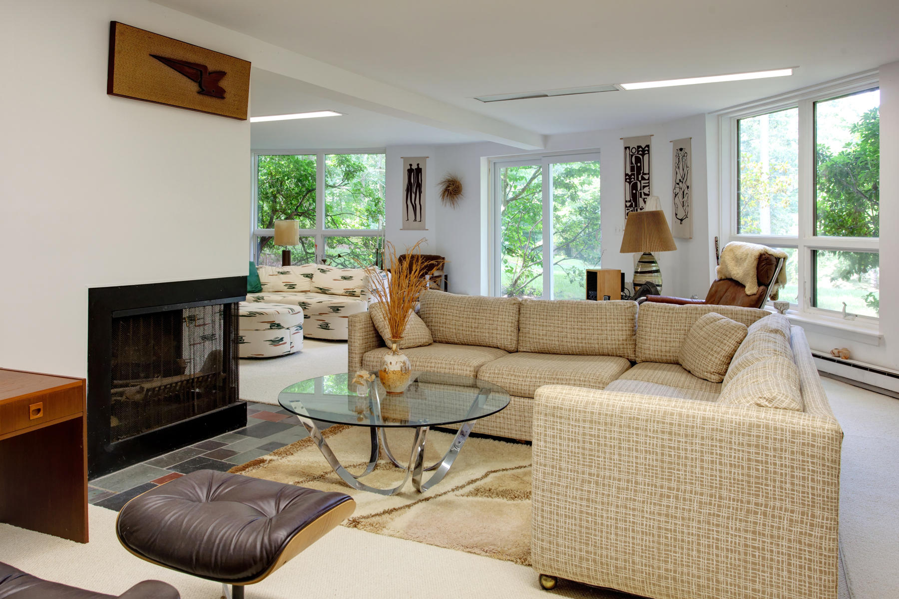167 Ralyn Road Cotuit, MA 02635 - Photo 16 of 32 a living room with furniture a large window and a fireplace