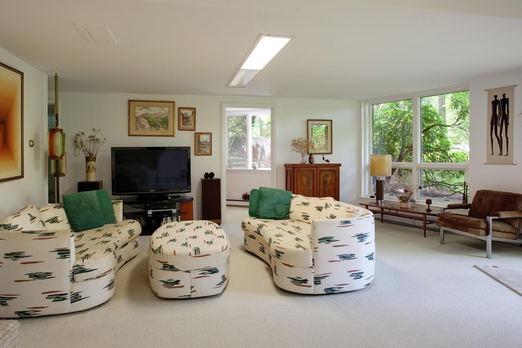 167 Ralyn Road Cotuit, MA 02635 - Photo 18 of 32 a living room with furniture a large window and a flat screen tv