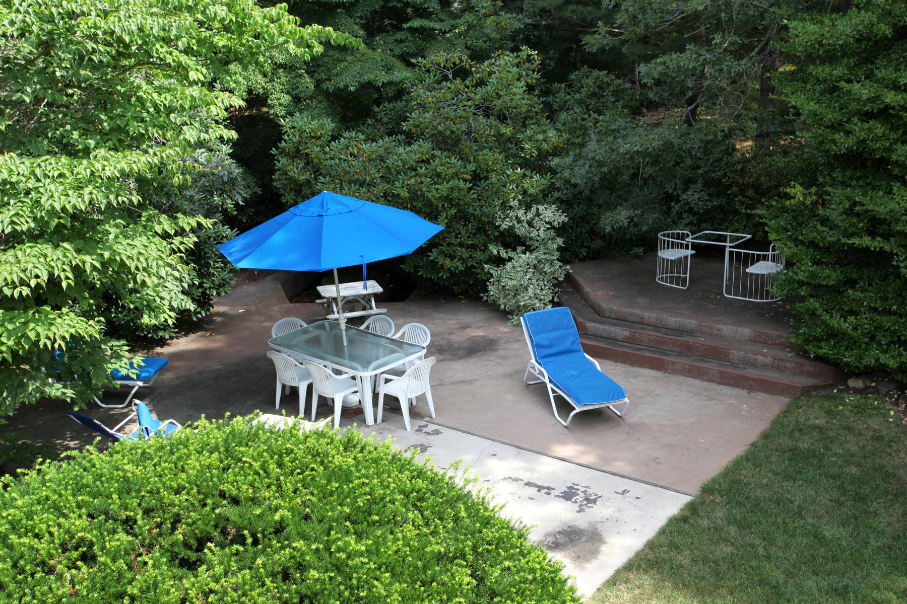 167 Ralyn Road Cotuit, MA 02635 - Photo 29 of 32 a view of a backyard with a patio and plants