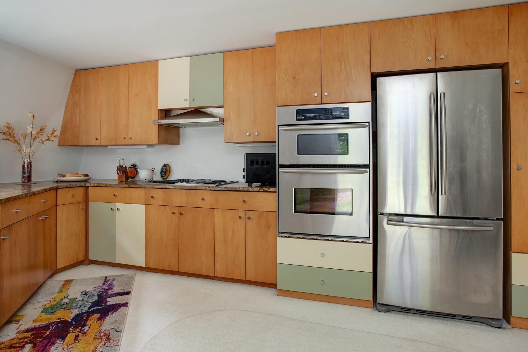 167 Ralyn Road Cotuit, MA 02635 - Photo 7 of 32 a kitchen with appliances a sink and lots of cabinets