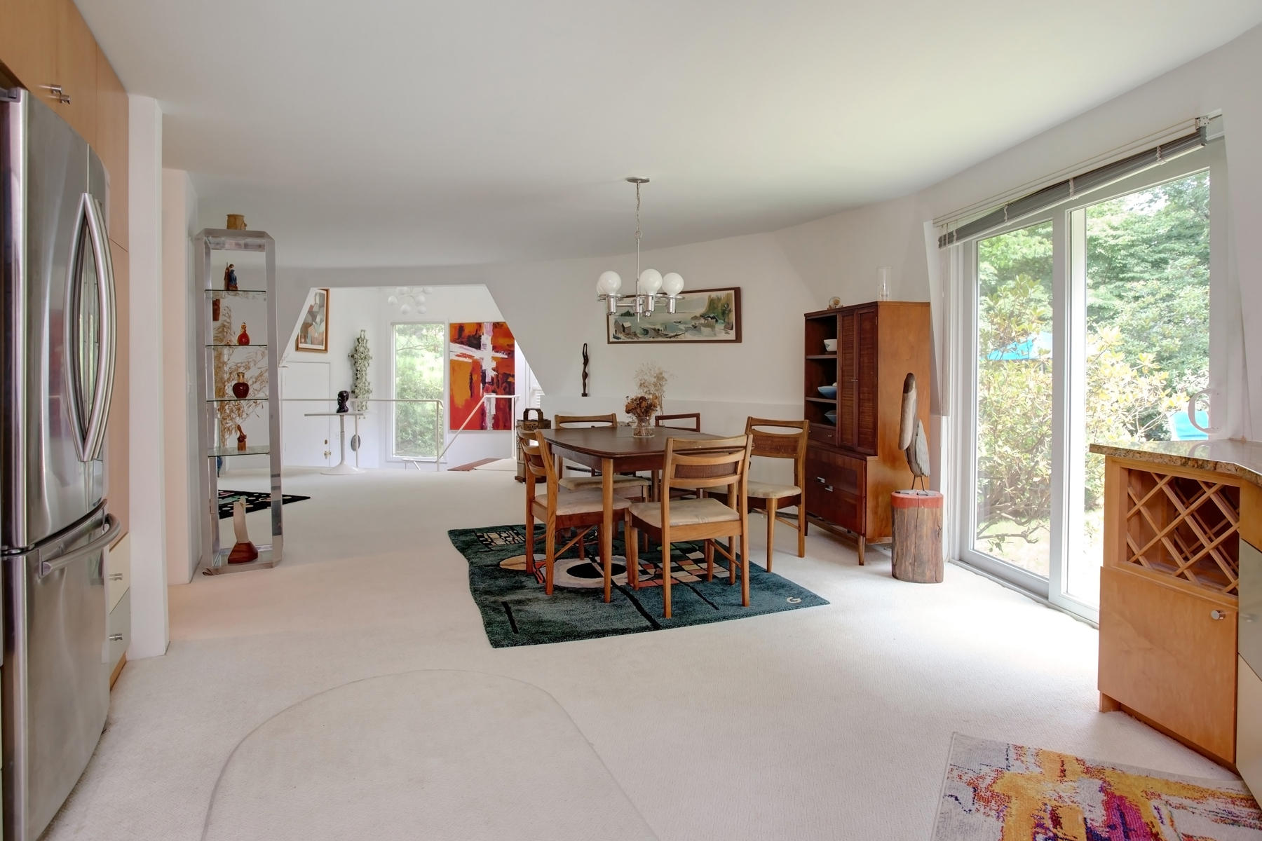 167 Ralyn Road Cotuit, MA 02635 - Photo 8 of 32 a living room with furniture a large window and gym equipment
