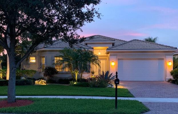 a front view of a house with a garden