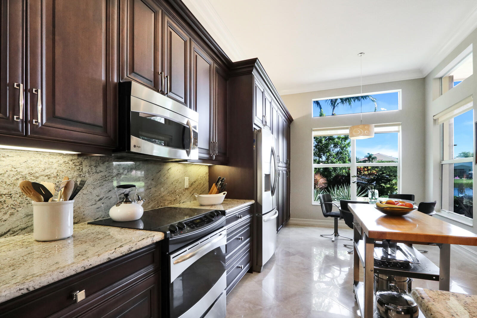 6967 Corning Circle Boynton Beach, FL 33437 - Photo 17 of 62 a kitchen with a stove a sink and a microwave